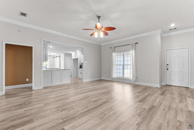 465 Pitts Rd, Hawkinsville, GA 31036 - unfurnished living room featuring a ceiling fan, light wood-style flooring, a textured ceiling, crown molding, and baseboards