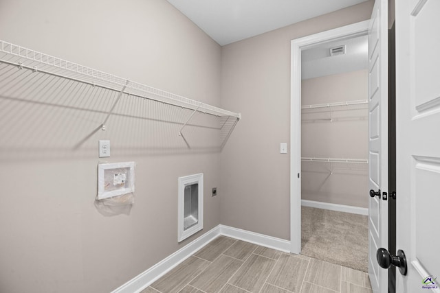 washroom featuring electric dryer hookup, baseboards, washer hookup, and wood tiled floors