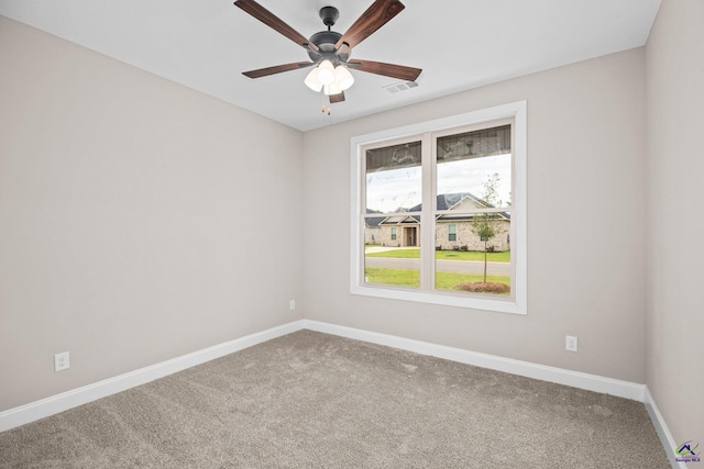 spare room with carpet floors, baseboards, and ceiling fan