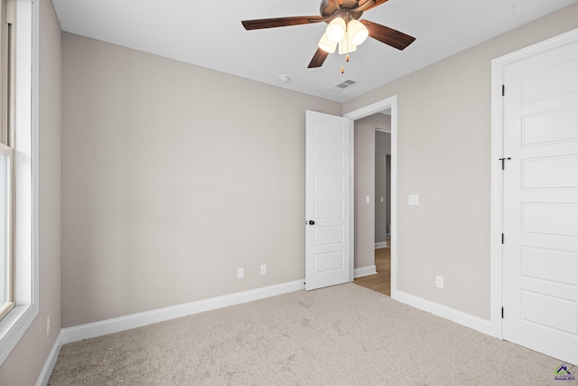 unfurnished bedroom with carpet, baseboards, and ceiling fan