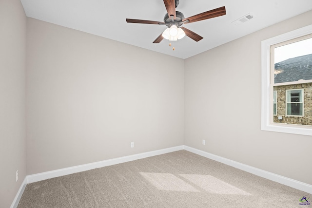 carpeted empty room with baseboards and ceiling fan