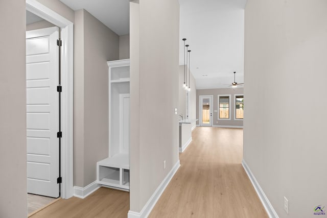 hallway with light wood-style flooring and baseboards