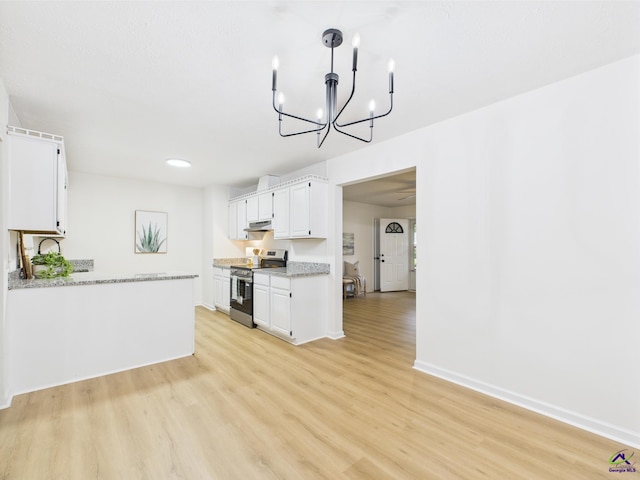104 Karen Dr, Warner Robins, GA 31088 - kitchen featuring stainless steel electric range oven, under cabinet range hood, white cabinetry, light wood-style floors, and a chandelier