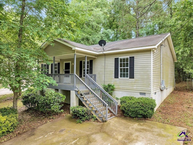 ranch-style house featuring crawl space, a porch, and stairs