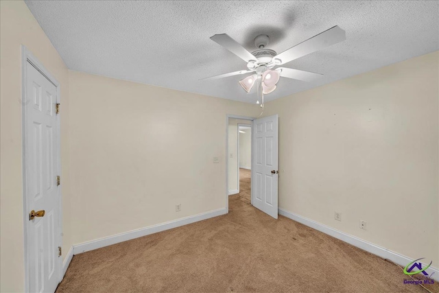 unfurnished bedroom featuring carpet floors, baseboards, a textured ceiling, and a ceiling fan