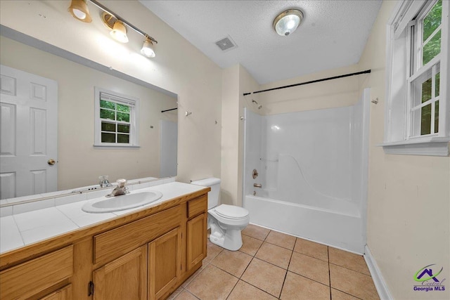 full bathroom with tile patterned flooring, toilet, shower / washtub combination, vanity, and a textured ceiling
