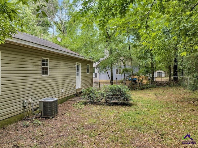 view of yard with cooling unit and fence