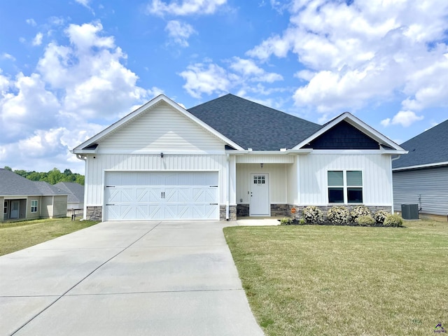 view of front facade featuring stone siding, driveway, an attached garage, and a front lawn