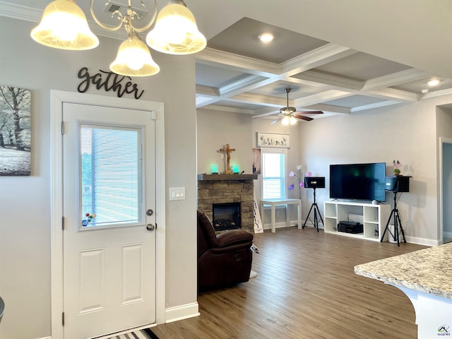 living room featuring wood finished floors, baseboards, a fireplace, beamed ceiling, and coffered ceiling