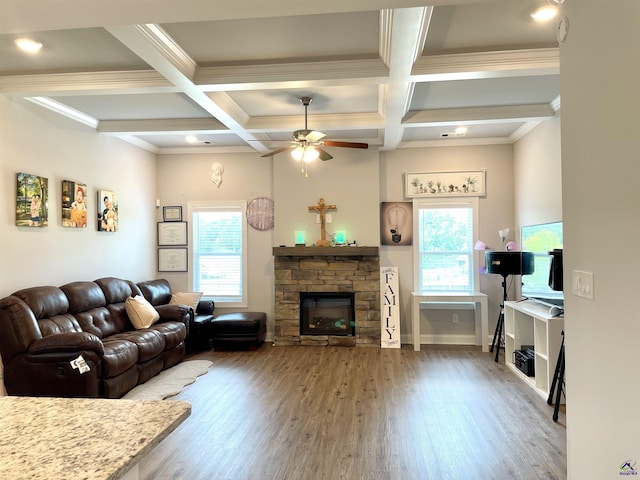 living area with plenty of natural light, coffered ceiling, wood finished floors, ceiling fan, and beamed ceiling