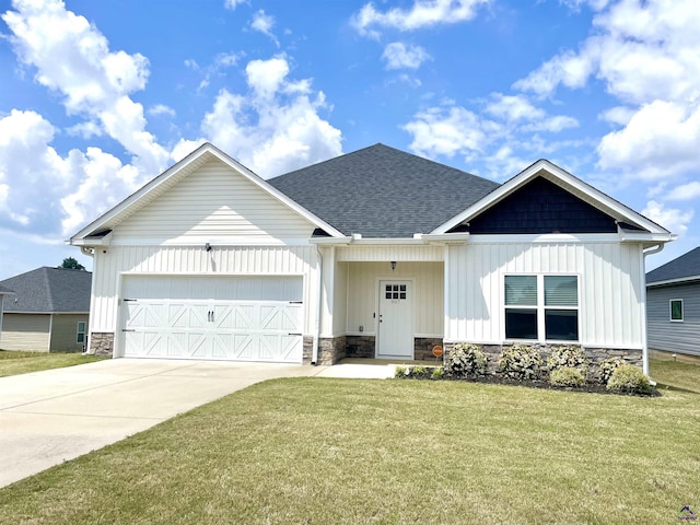 view of front of house featuring an attached garage, stone siding, a front lawn, concrete driveway, and a shingled roof