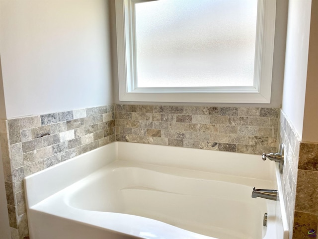 full bathroom featuring healthy amount of natural light and a garden tub