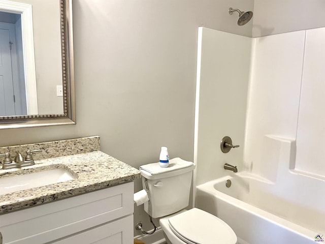 bathroom with toilet, vanity, and tub / shower combination