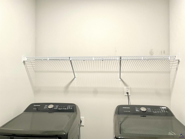 clothes washing area featuring independent washer and dryer