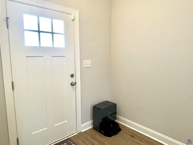 entryway featuring baseboards and dark wood-style flooring