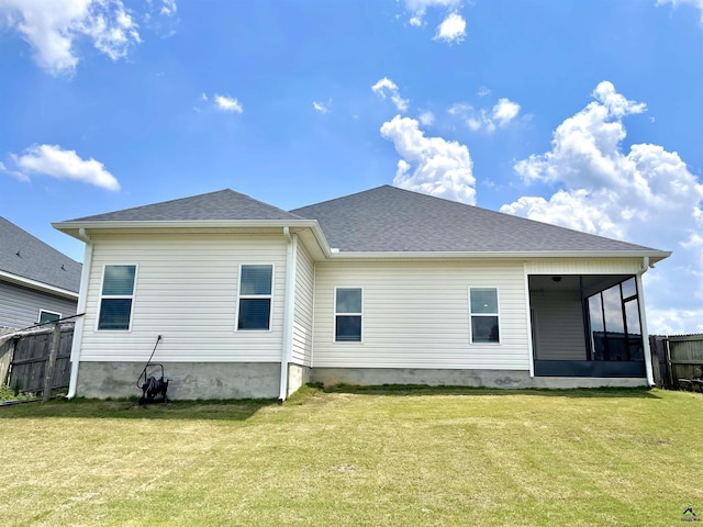 rear view of property featuring a sunroom and roof with shingles