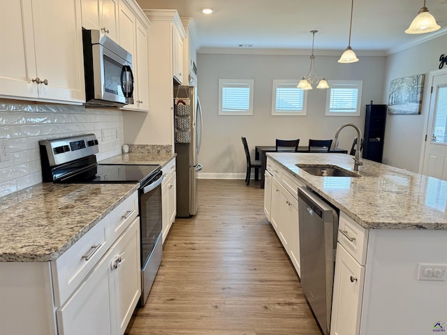907 Adirondac Way, Bonaire, GA 31005 - kitchen with stainless steel appliances, a sink, white cabinets, a center island with sink, and tasteful backsplash