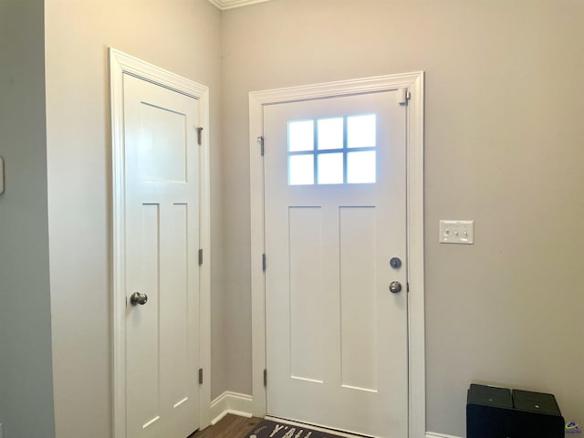 doorway to outside with baseboards
