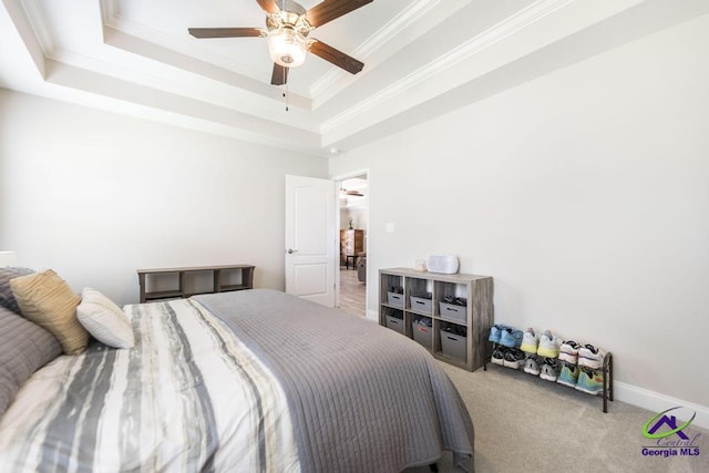 bedroom featuring crown molding, carpet, a raised ceiling, ceiling fan, and baseboards