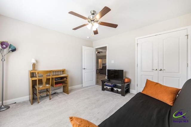 sitting room featuring ceiling fan, light carpet, and baseboards