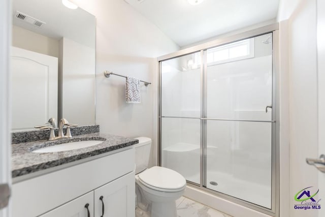full bath with marble look tiles, a stall shower, toilet, and vanity