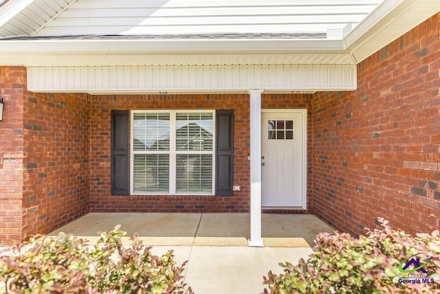 property entrance with brick siding