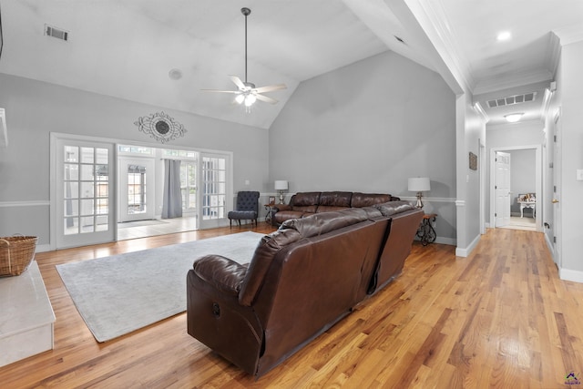 living area with a ceiling fan, light wood-style floors, crown molding, high vaulted ceiling, and baseboards