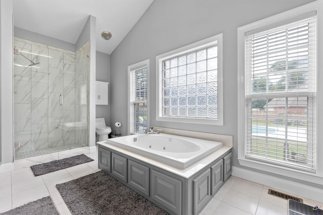 bathroom featuring a whirlpool tub, toilet, a shower stall, vaulted ceiling, and tile patterned floors