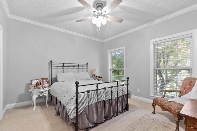 bedroom with light colored carpet, a textured ceiling, ornamental molding, baseboards, and a ceiling fan