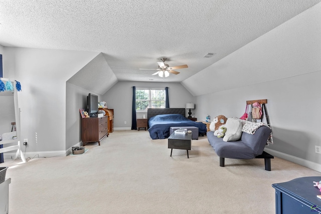 carpeted bedroom with lofted ceiling, a textured ceiling, baseboards, and a ceiling fan