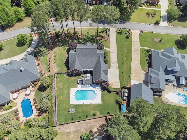view of property location with a pool area and nearby suburban area