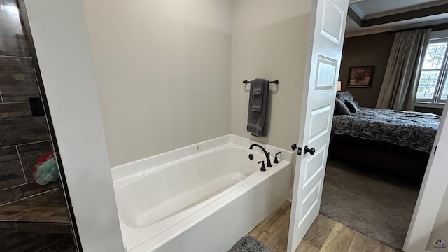 17 Creekside Trl, Forsyth, GA 31029 - ensuite bathroom with wood finished floors and a garden tub