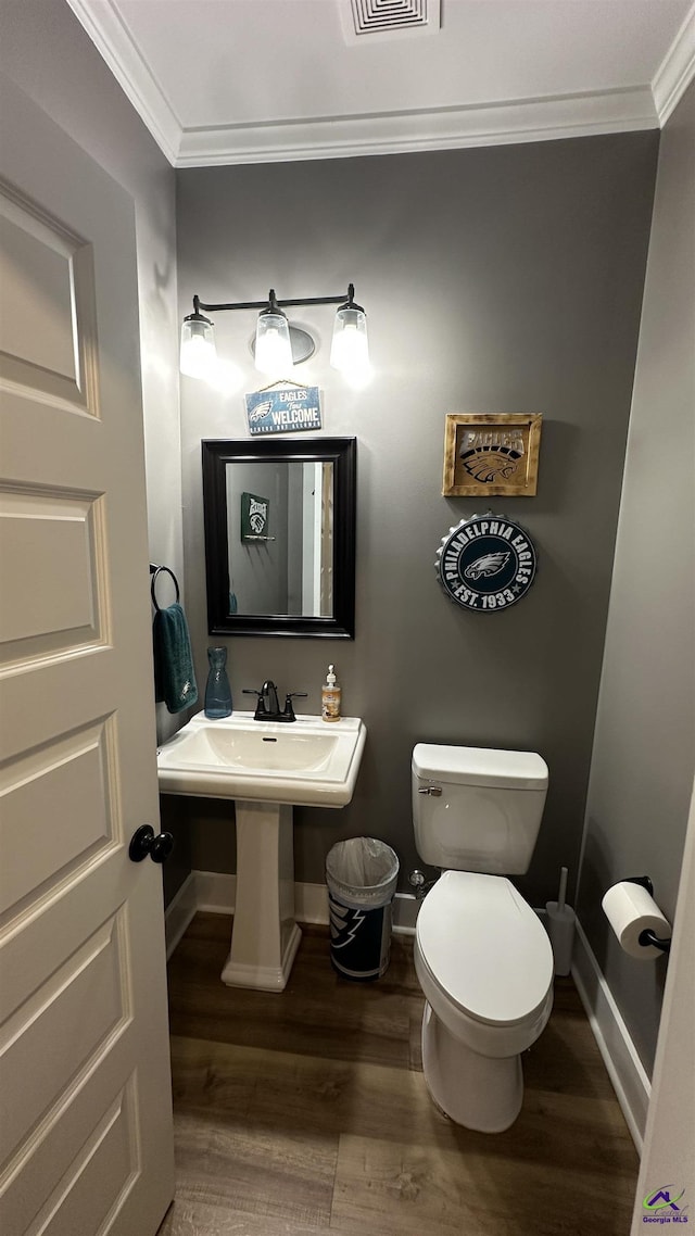 17 Creekside Trl, Forsyth, GA 31029 - bathroom featuring crown molding, wood finished floors, baseboards, toilet, and a sink