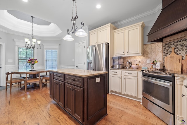 kitchen with appliances with stainless steel finishes, custom exhaust hood, a chandelier, dark brown cabinetry, and crown molding