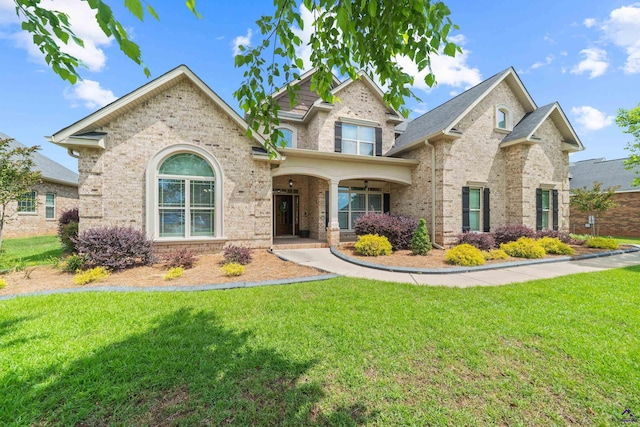 traditional-style house featuring brick siding and a front yard