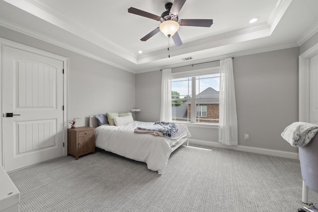 bedroom with a tray ceiling, light colored carpet, ornamental molding, recessed lighting, and baseboards