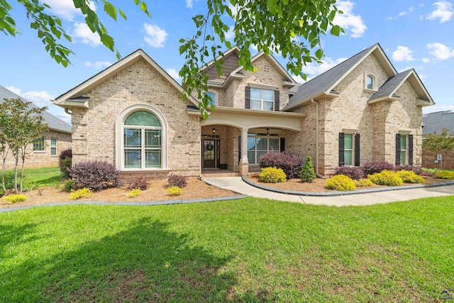 view of front of property with brick siding and a front lawn