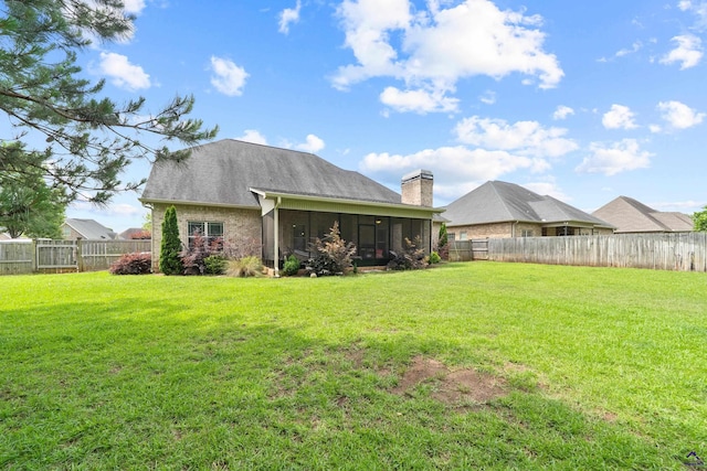 back of property with a sunroom and a chimney