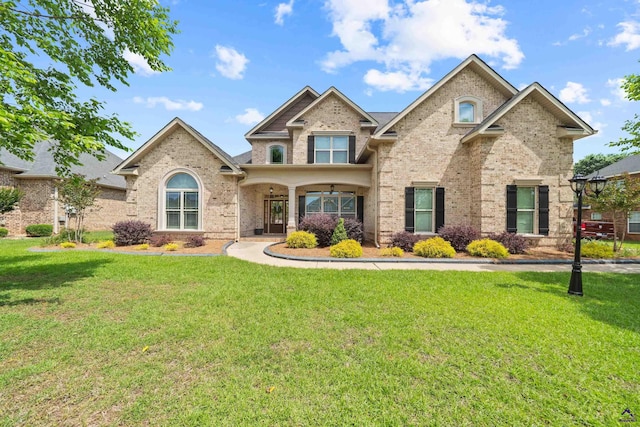 view of front of house featuring a front yard and brick siding