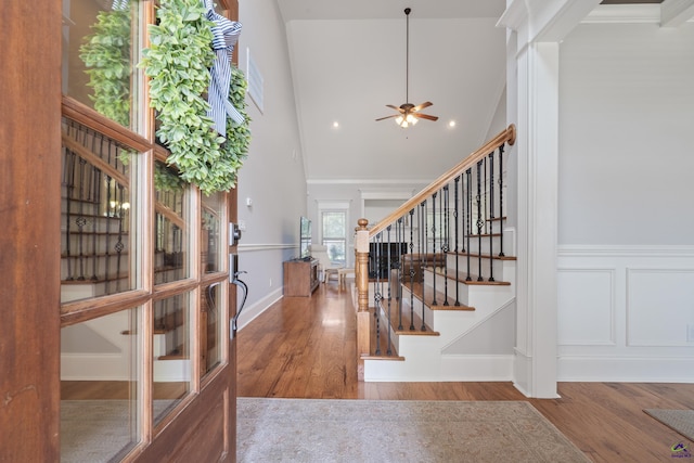 foyer entrance featuring stairway, wood finished floors, a ceiling fan, high vaulted ceiling, and recessed lighting
