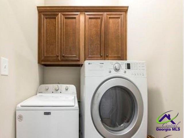 laundry area featuring cabinet space and separate washer and dryer