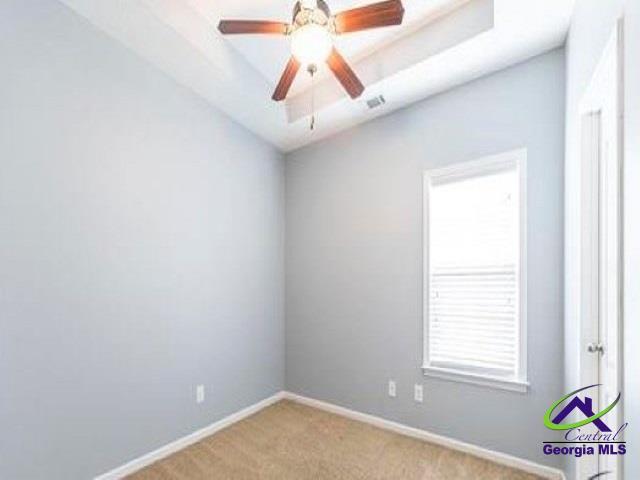 unfurnished room featuring carpet flooring, baseboards, a ceiling fan, and lofted ceiling