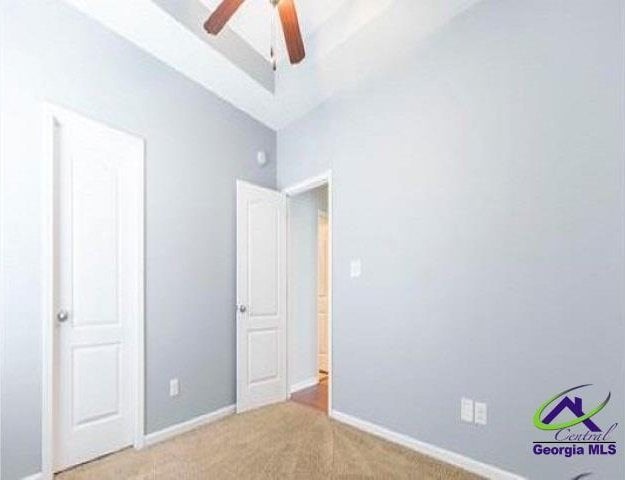 unfurnished bedroom featuring carpet flooring and baseboards