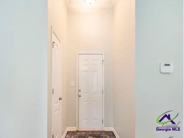 doorway to outside featuring baseboards