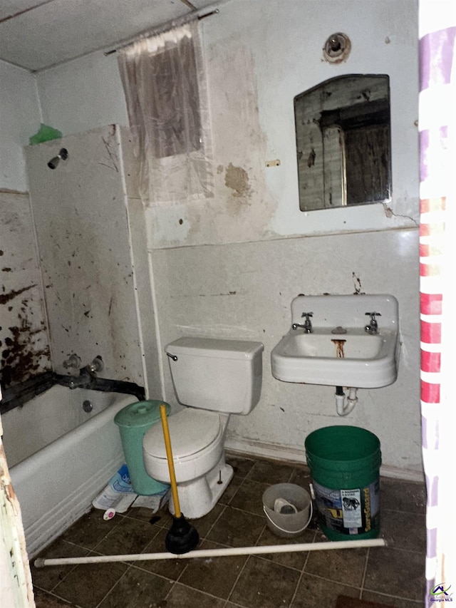 62 Merritt St, Hawkinsville, GA 31036 - bathroom featuring tile patterned flooring, toilet, a sink, and bathing tub / shower combination