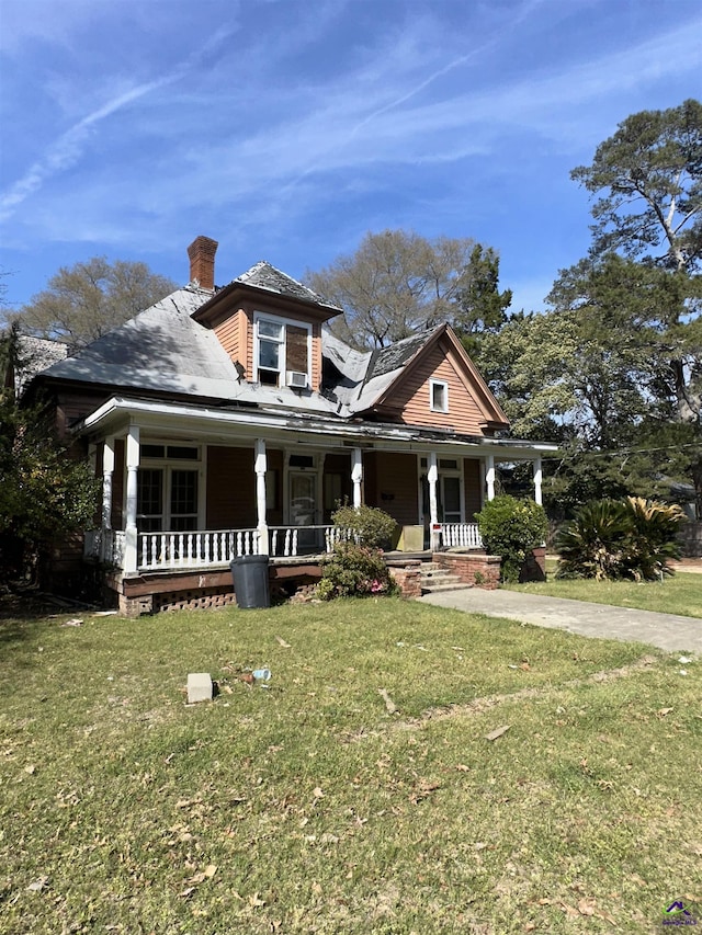 62 Merritt St, Hawkinsville, GA 31036 - view of front of property featuring covered porch, a chimney, and a front lawn