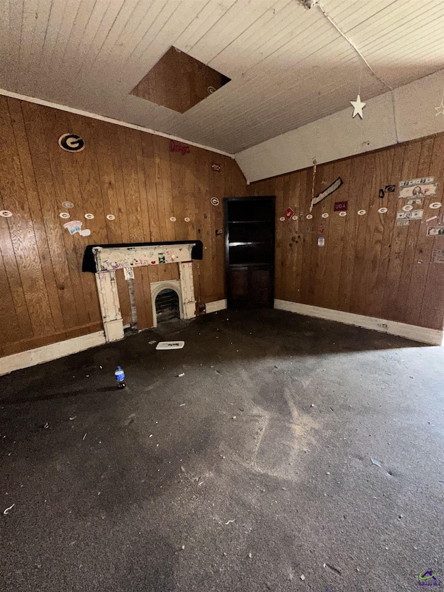 62 Merritt St, Hawkinsville, GA 31036 - unfurnished living room featuring wooden walls, lofted ceiling, and baseboards