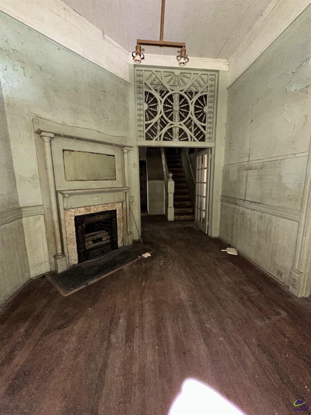 62 Merritt St, Hawkinsville, GA 31036 - unfurnished living room featuring wood finished floors, a fireplace with raised hearth, and ornamental molding