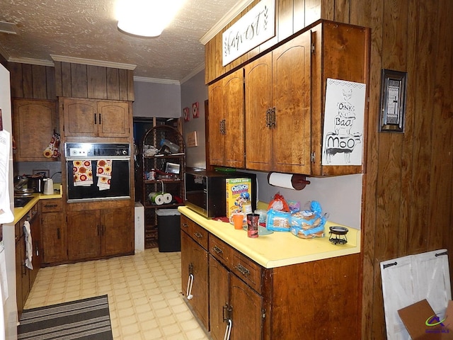 7085 US Highway 341 S, Roberta, GA 31078 - kitchen with oven, light flooring, light countertops, brown cabinets, and ornamental molding