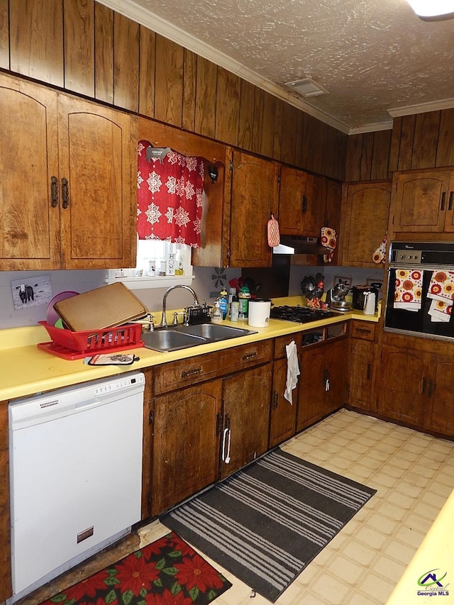 7085 US Highway 341 S, Roberta, GA 31078 - kitchen featuring white dishwasher, black oven, a sink, light floors, and ornamental molding